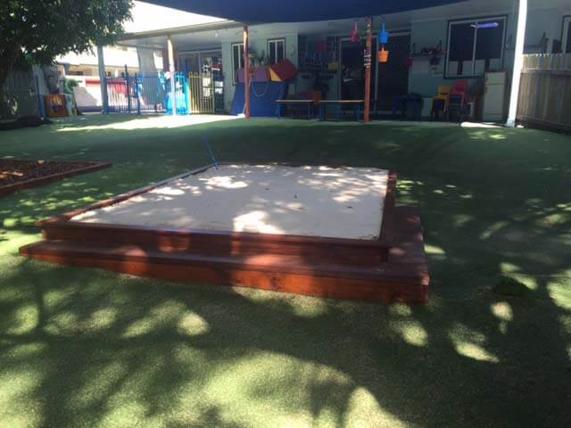 timber sandpit at garden